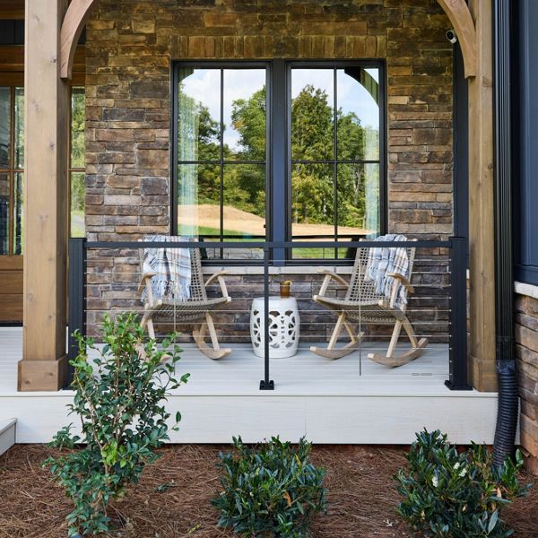 The front porch of the HGTV Dream Home where the Trex Transcend Lineage color Salt Flat is accented by Trex Signature X-Series Cable Railing.